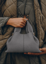 Elegant Minimalist Slate Grey Pebbled Leather Top Handle Handbag with Soft Sculptural Silhouette and Gold Hardware – Modern Quiet Luxury Designer Accessory Product Shot