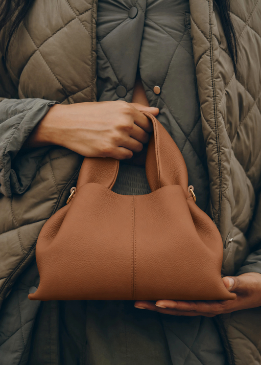 Elegant Winter Minimalist Look Featuring Ivory Textured Wool Coat and Cream Tailored Trousers with Structured Cognac Leather Top Handle Handbag – Timeless Quiet Luxury Womenswear Editorial Style