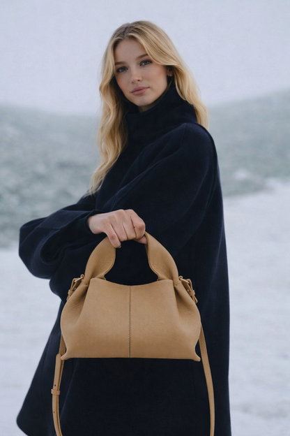 Sophisticated Minimalist Winter Look Featuring Oversized Black Wool Coat with Structured Camel Leather Crossbody Top Handle Handbag – Modern Quiet Luxury Womenswear Editorial Style