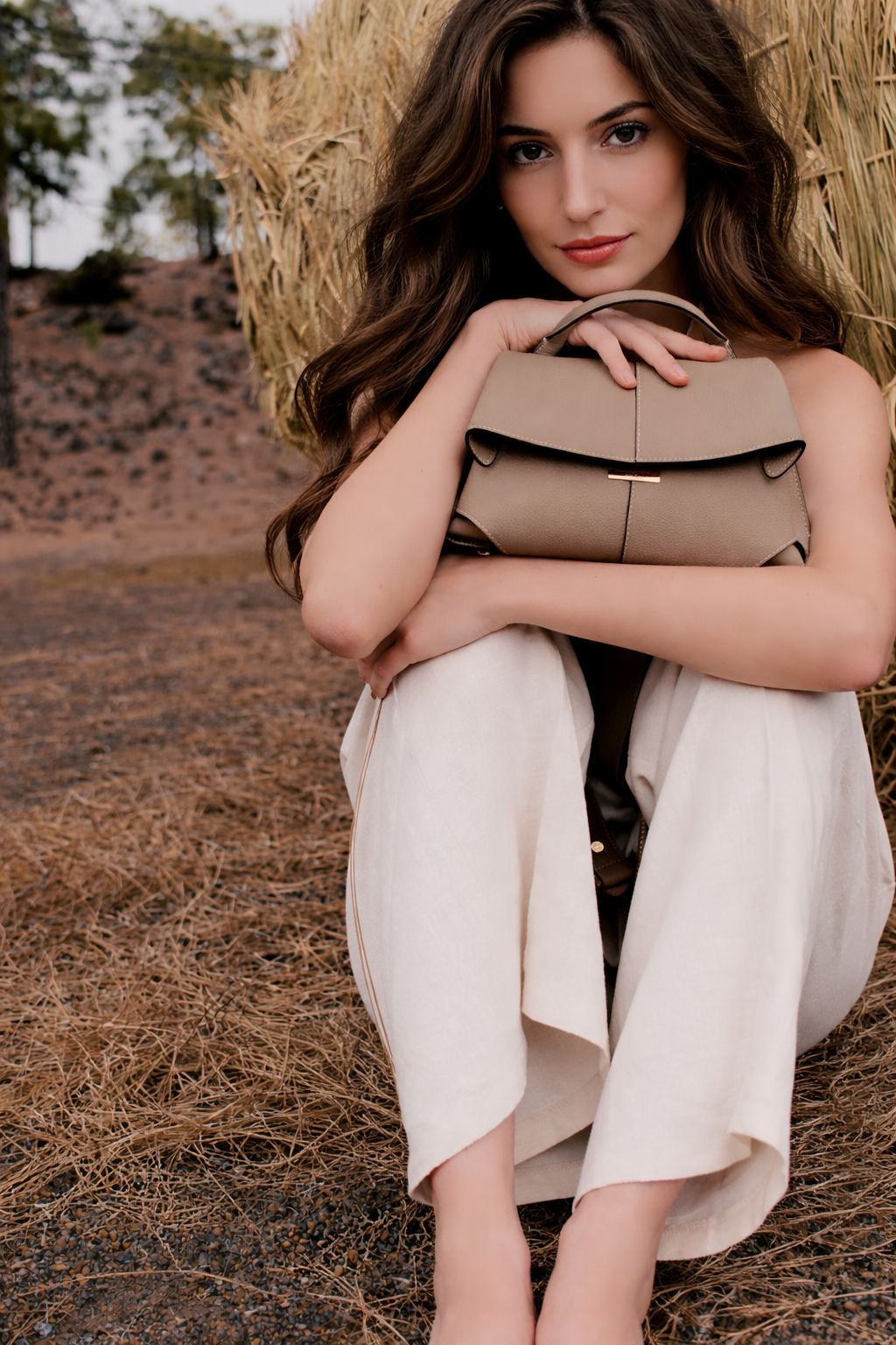 Taupe Leather Top-Handle Shoulder Bag Styled on Model in Neutral Sleeveless Dress