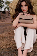 Taupe Leather Top-Handle Shoulder Bag Styled on Model in Neutral Sleeveless Dress