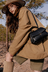 Elegant Black Pebbled Leather Top-Handle Handbag with Fold-Over Flap, Contrast Stitching, and Gold-Tone Hardware