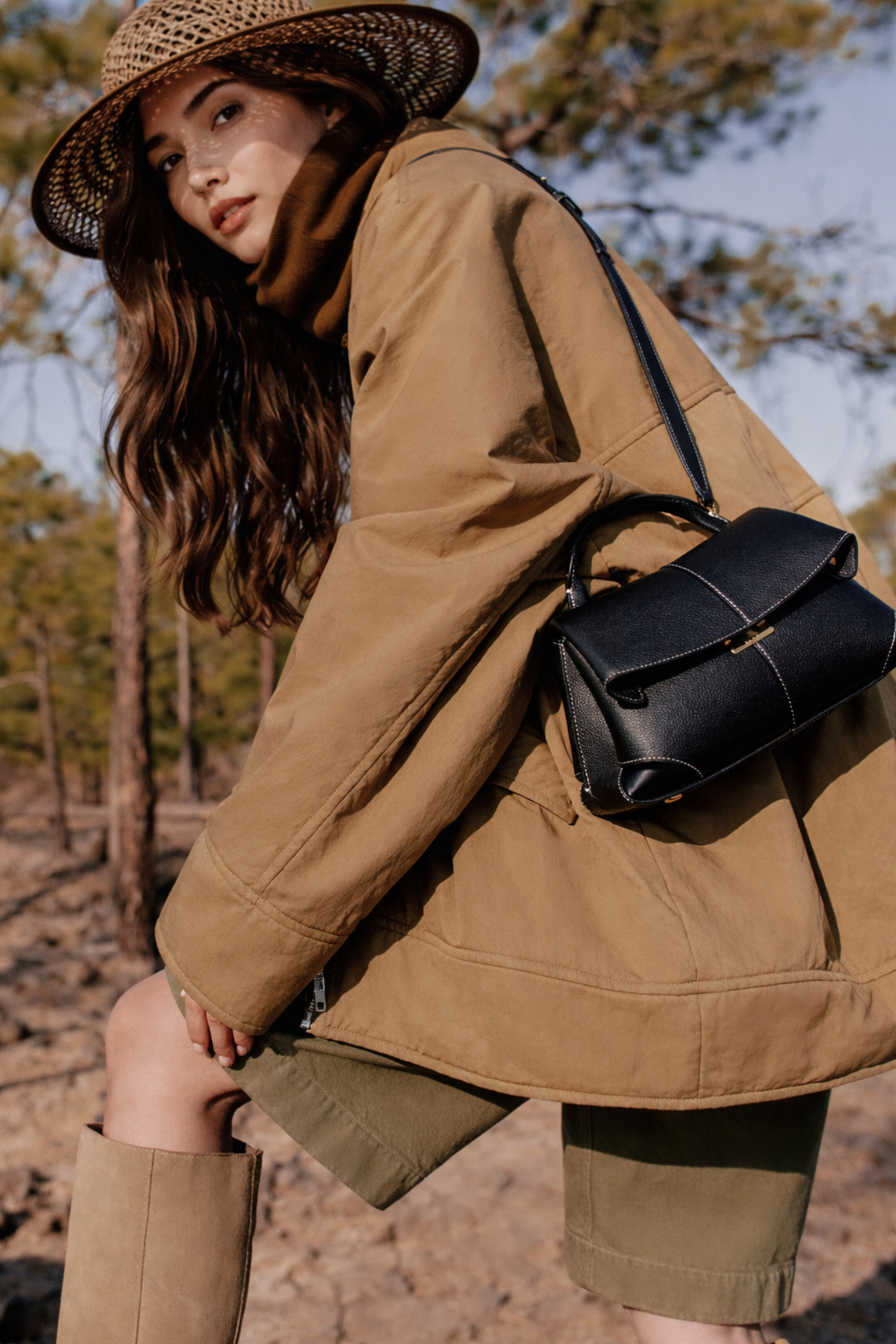 Elegant Black Pebbled Leather Top-Handle Handbag with Fold-Over Flap, Contrast Stitching, and Gold-Tone Hardware