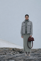 Elegant Burgundy Pebbled Leather Top-Handle Shoulder Bag with Fold-Over Flap and Gold-Tone Hardware Styled with Cozy Grey Outerwear