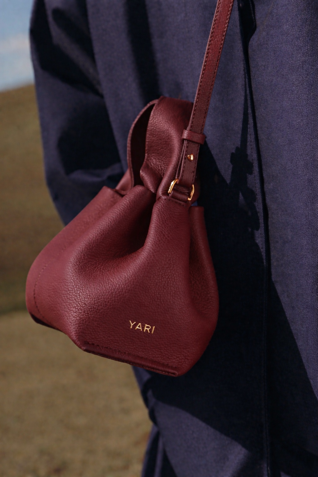 Refined Minimalist Winter Outfit Featuring Soft Ivory Textured Coat and Cream Tailored Trousers with Deep Burgundy Leather Crossbody Top Handle Handbag – Elegant Quiet Luxury Womenswear Editorial Style