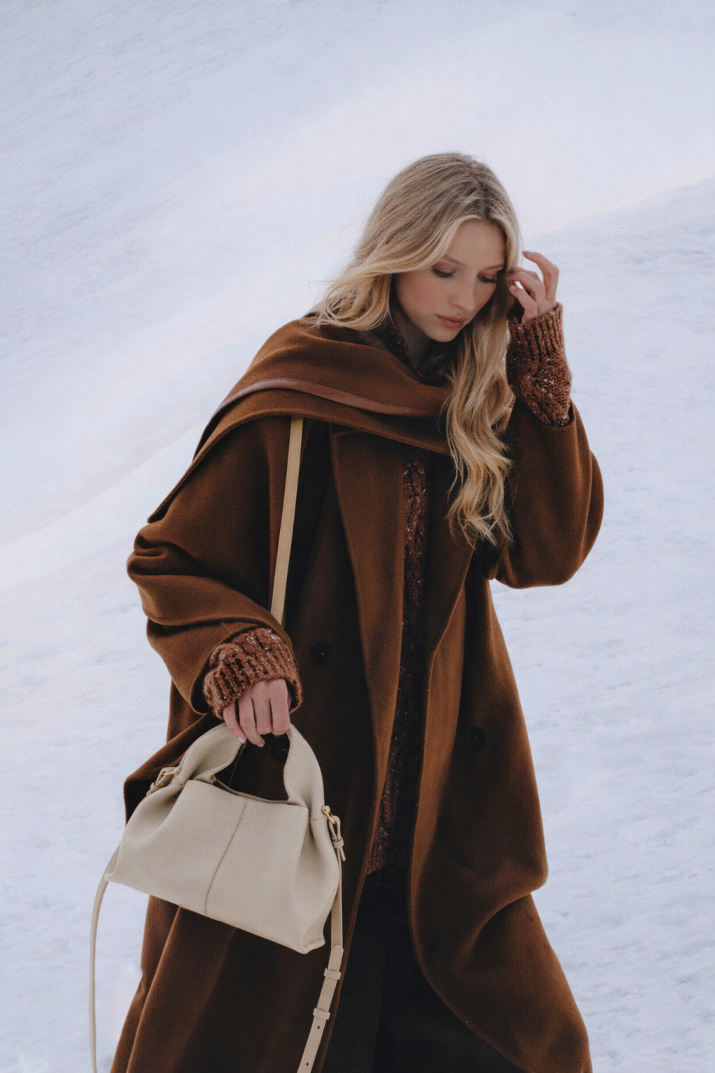 Elegant Winter Minimalist Look Featuring Rich Chocolate Wool Coat and Textured Knit Sleeves with Structured Stone Beige Leather Top Handle Handbag – Timeless Quiet Luxury Womenswear Editorial Style