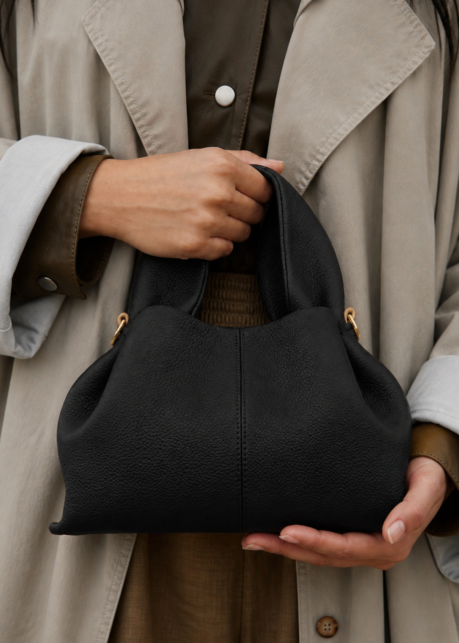 Sophisticated Minimalist Trench Coat Ensemble Featuring Oversized Stone Beige Outerwear and Layered Neutral Tailoring with Structured Black Leather Top Handle Handbag – Modern Quiet Luxury Womenswear Editorial Look