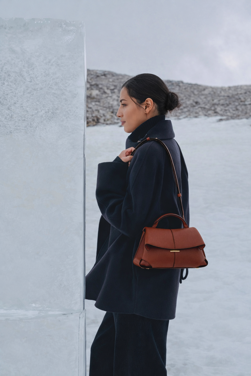 Elegant Cognac Pebbled Leather Top-Handle Shoulder Bag with Fold-Over Flap, Adjustable Strap, and Gold-Tone Hardware Styled in Modern Winter Look