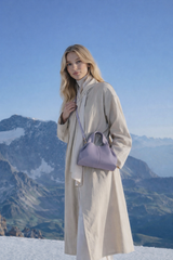 Elegant Minimalist Resort Look Featuring Flowing Ivory Tunic Dress and Draped Neutral Layers with Structured Soft Lilac Leather Top Handle Handbag – Modern Quiet Luxury Womenswear Editorial Style