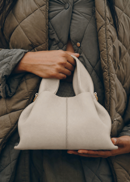 Elegant Winter Minimalist Look Featuring Rich Chocolate Wool Coat and Textured Knit Sleeves with Structured Stone Beige Leather Top Handle Handbag – Timeless Quiet Luxury Womenswear Editorial Style