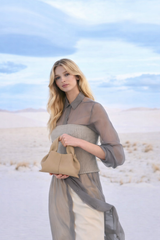 Modern Minimalist Neutral Outfit Featuring Sheer Taupe Button-Up Shirt Layered Over Ribbed Knit Bustier with Flowing Trousers and Structured Sand Beige Leather Top Handle Handbag – Elegant Contemporary Womenswear Editorial Look