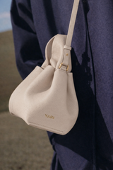 Elegant Winter Minimalist Look Featuring Rich Chocolate Wool Coat and Textured Knit Sleeves with Structured Stone Beige Leather Top Handle Handbag – Timeless Quiet Luxury Womenswear Editorial Style