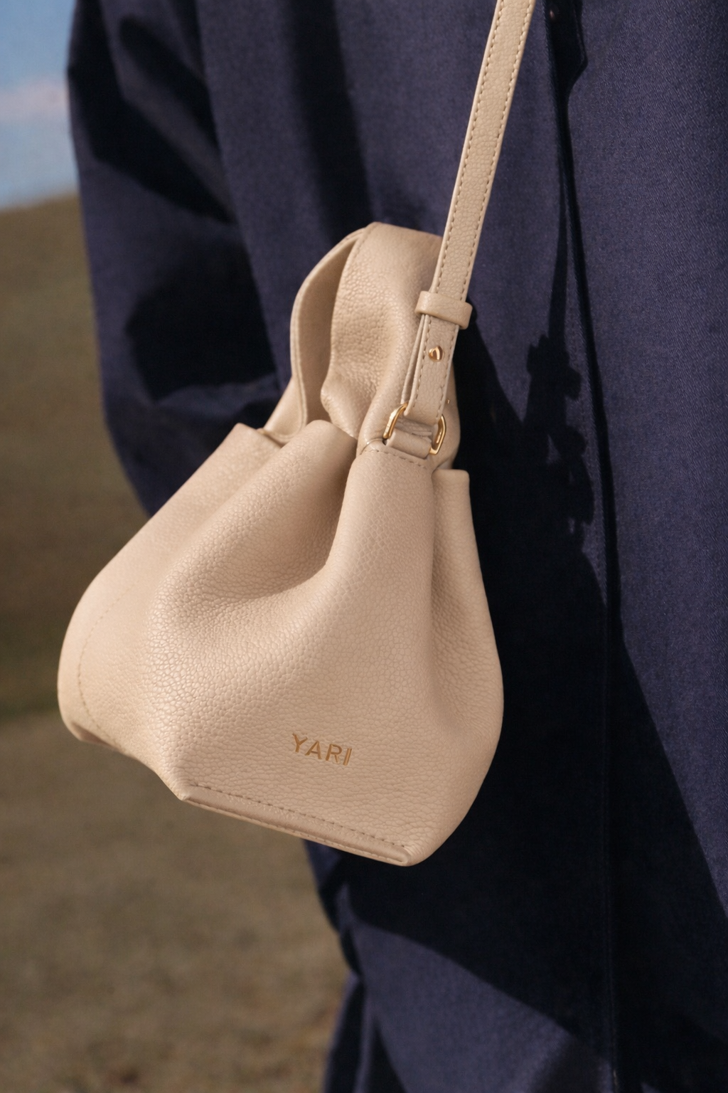 Modern Minimalist Neutral Outfit Featuring Sheer Taupe Button-Up Shirt Layered Over Ribbed Knit Bustier with Flowing Trousers and Structured Sand Beige Leather Top Handle Handbag – Elegant Contemporary Womenswear Editorial Look