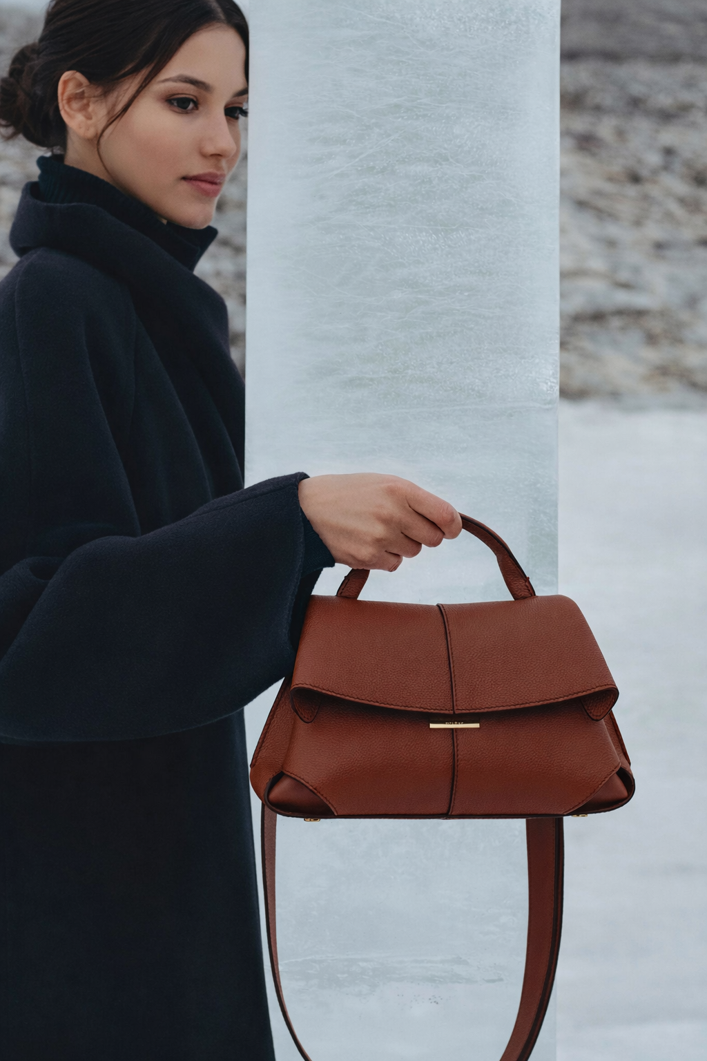 Elegant Cognac Pebbled Leather Top-Handle Shoulder Bag with Fold-Over Flap, Adjustable Strap, and Gold-Tone Hardware Styled in Modern Winter Look
