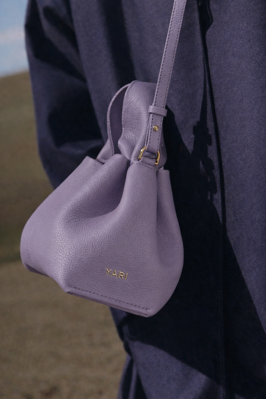 Elegant Minimalist Resort Look Featuring Flowing Ivory Tunic Dress and Draped Neutral Layers with Structured Soft Lilac Leather Top Handle Handbag – Modern Quiet Luxury Womenswear Editorial Style