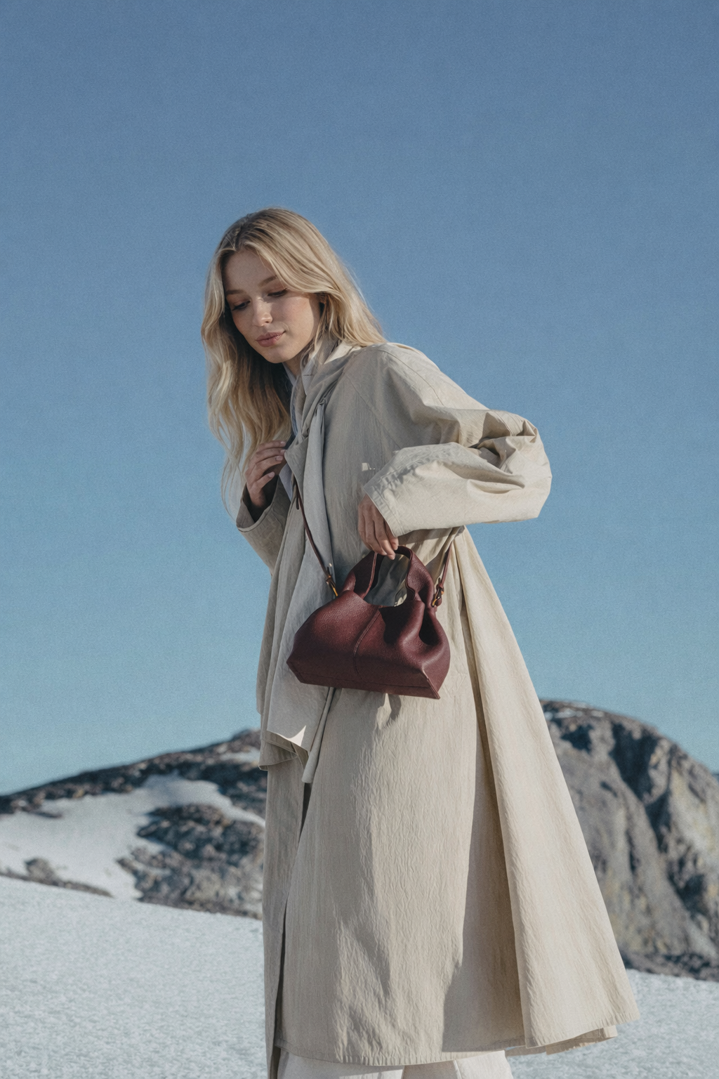 Refined Minimalist Winter Outfit Featuring Soft Ivory Textured Coat and Cream Tailored Trousers with Deep Burgundy Leather Crossbody Top Handle Handbag – Elegant Quiet Luxury Womenswear Editorial Style