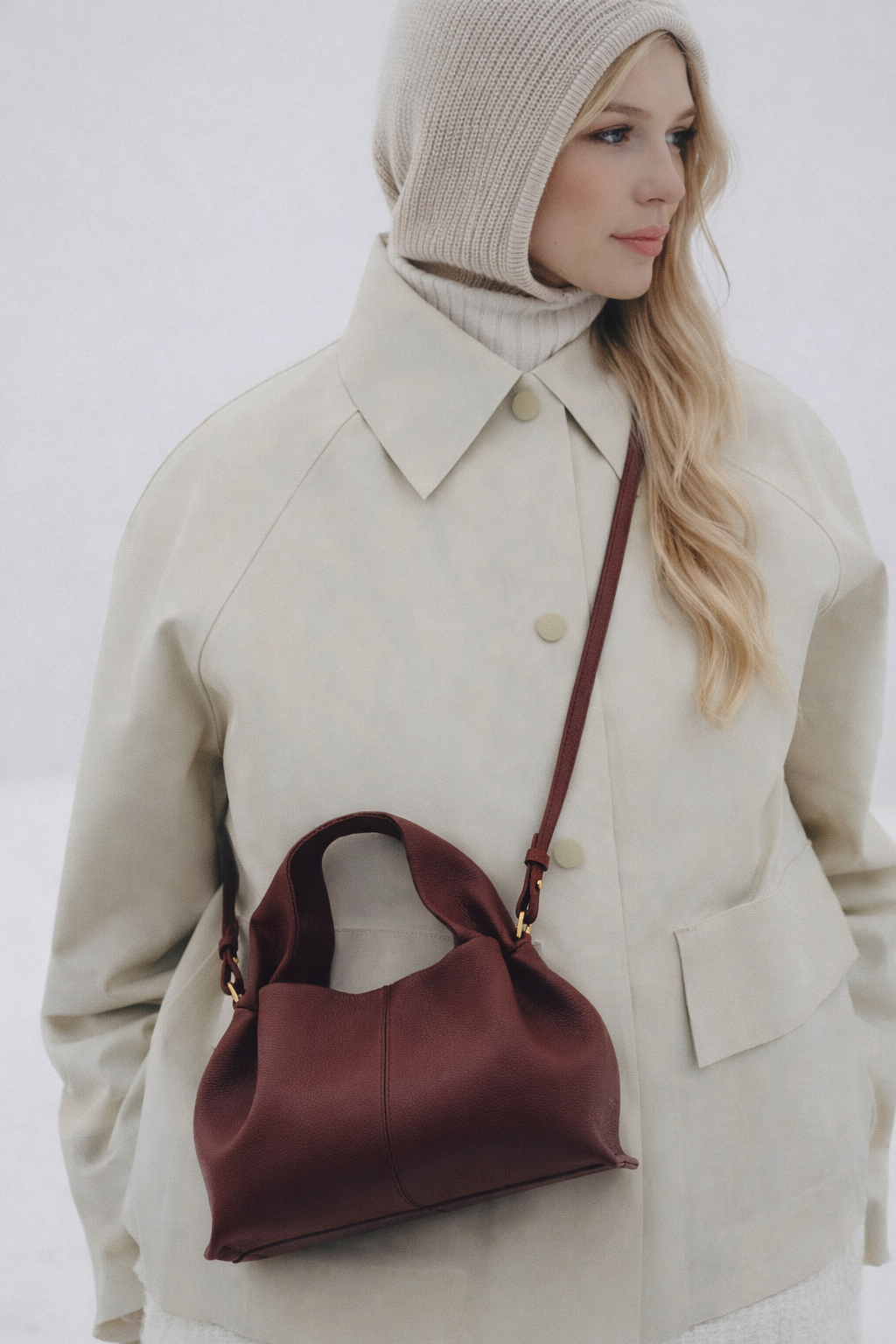 Elegant Minimalist Winter Look Featuring Soft Ivory Textured Coat with Structured Deep Burgundy Leather Crossbody Top Handle Handbag – Timeless Quiet Luxury Womenswear Editorial Style