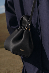 Sophisticated Minimalist Trench Coat Ensemble Featuring Oversized Stone Beige Outerwear and Layered Neutral Tailoring with Structured Black Leather Top Handle Handbag – Modern Quiet Luxury Womenswear Editorial Look