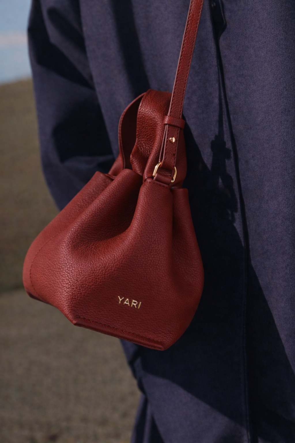 Elegant Minimalist Winter Look Featuring Soft Ivory Textured Coat with Structured Deep Burgundy Leather Crossbody Top Handle Handbag – Timeless Quiet Luxury Womenswear Editorial Style