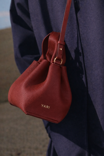 Elegant Minimalist Winter Look Featuring Soft Ivory Textured Coat with Structured Deep Burgundy Leather Crossbody Top Handle Handbag – Timeless Quiet Luxury Womenswear Editorial Style