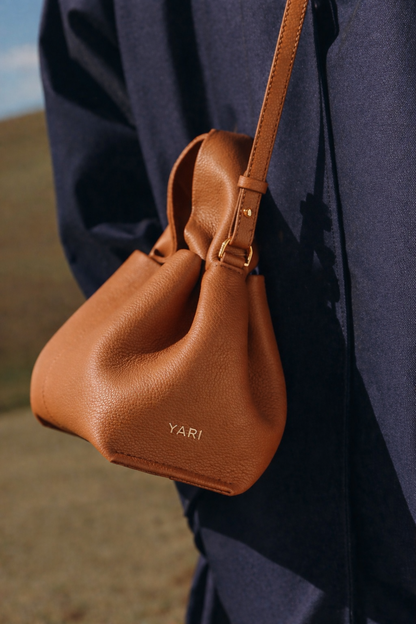 Elegant Winter Minimalist Look Featuring Ivory Textured Wool Coat and Cream Tailored Trousers with Structured Cognac Leather Top Handle Handbag – Timeless Quiet Luxury Womenswear Editorial Style