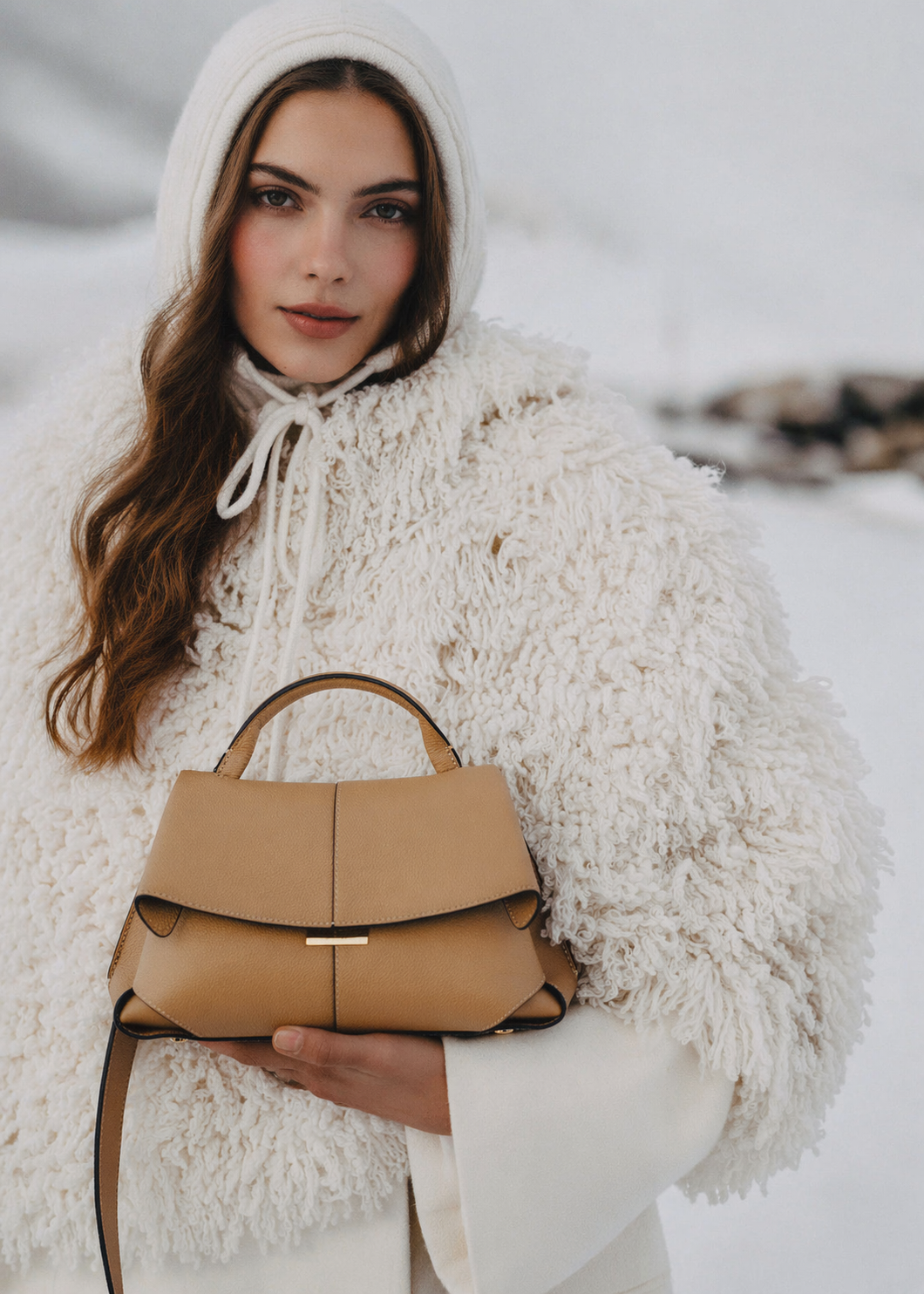 Elegant Camel Pebbled Leather Top-Handle Handbag with Fold-Over Flap, Adjustable Strap, and Gold-Tone Hardware Styled in Luxe Winter Look