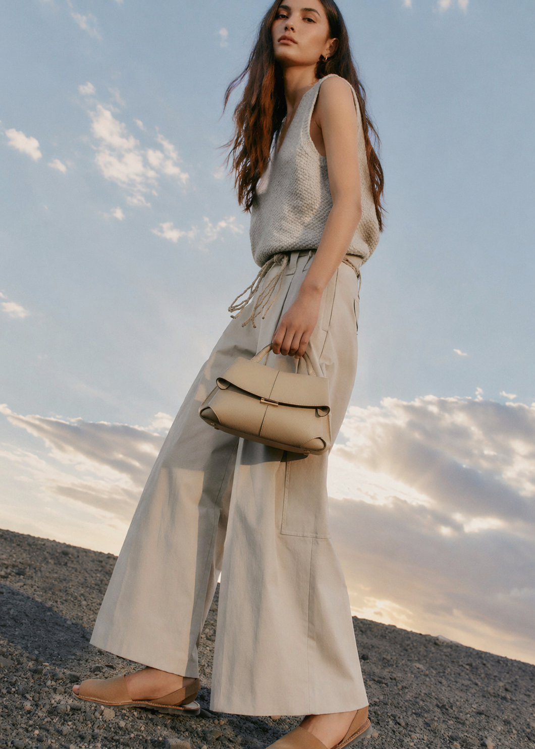Elegant Beige Pebbled Leather Top-Handle Handbag with Fold-Over Flap and Minimalist Structured Silhouette Styled in Soft Neutral Look