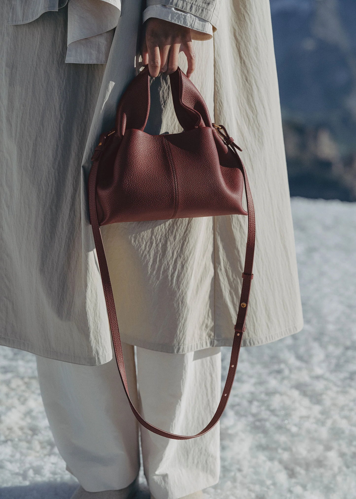 Refined Minimalist Winter Outfit Featuring Soft Ivory Textured Coat and Cream Tailored Trousers with Deep Burgundy Leather Crossbody Top Handle Handbag – Elegant Quiet Luxury Womenswear Editorial Style