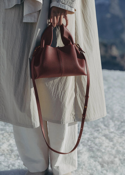 Refined Minimalist Winter Outfit Featuring Soft Ivory Textured Coat and Cream Tailored Trousers with Deep Burgundy Leather Crossbody Top Handle Handbag – Elegant Quiet Luxury Womenswear Editorial Style