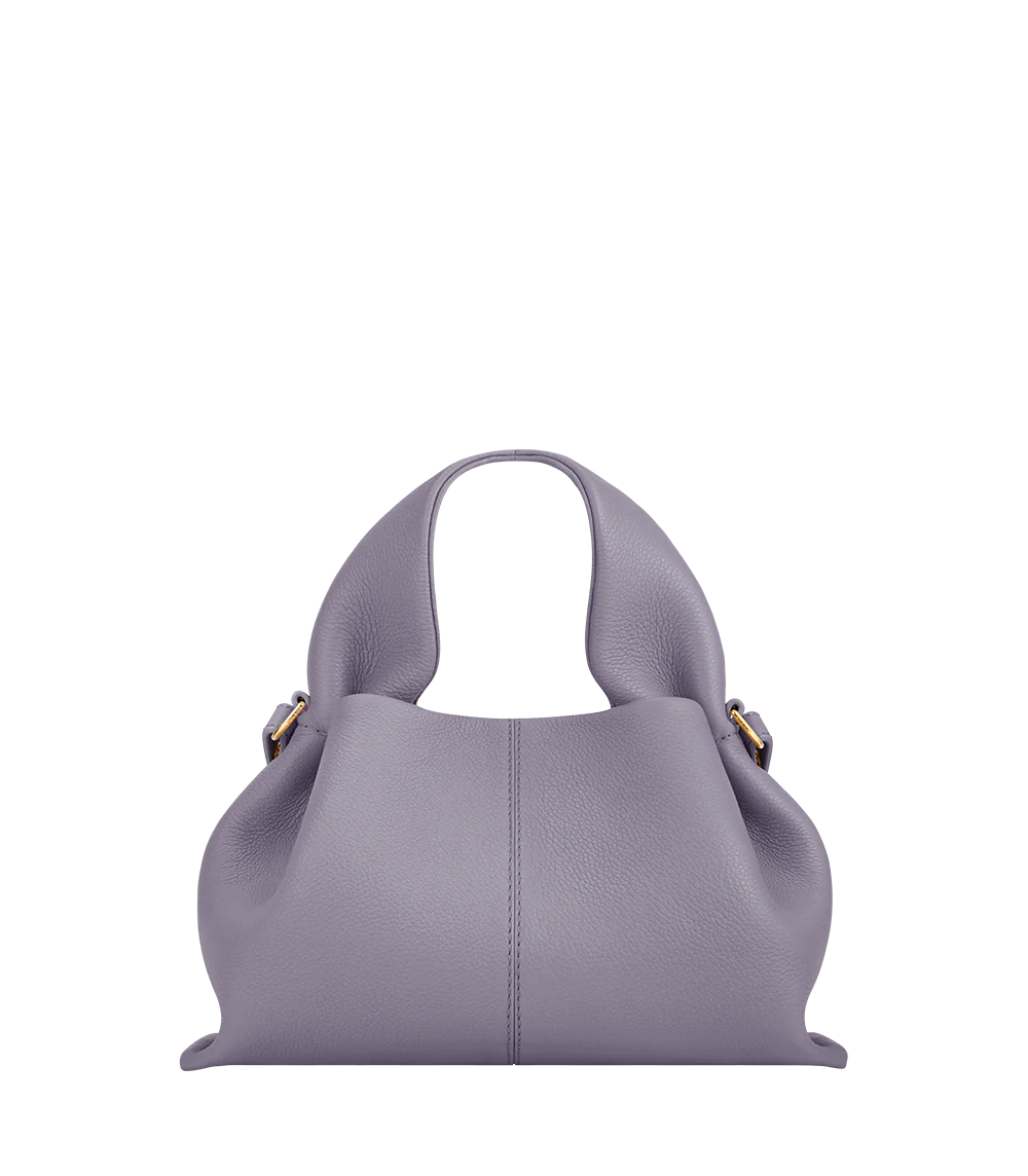 Elegant Minimalist Resort Look Featuring Flowing Ivory Tunic Dress and Draped Neutral Layers with Structured Soft Lilac Leather Top Handle Handbag – Modern Quiet Luxury Womenswear Editorial Style
