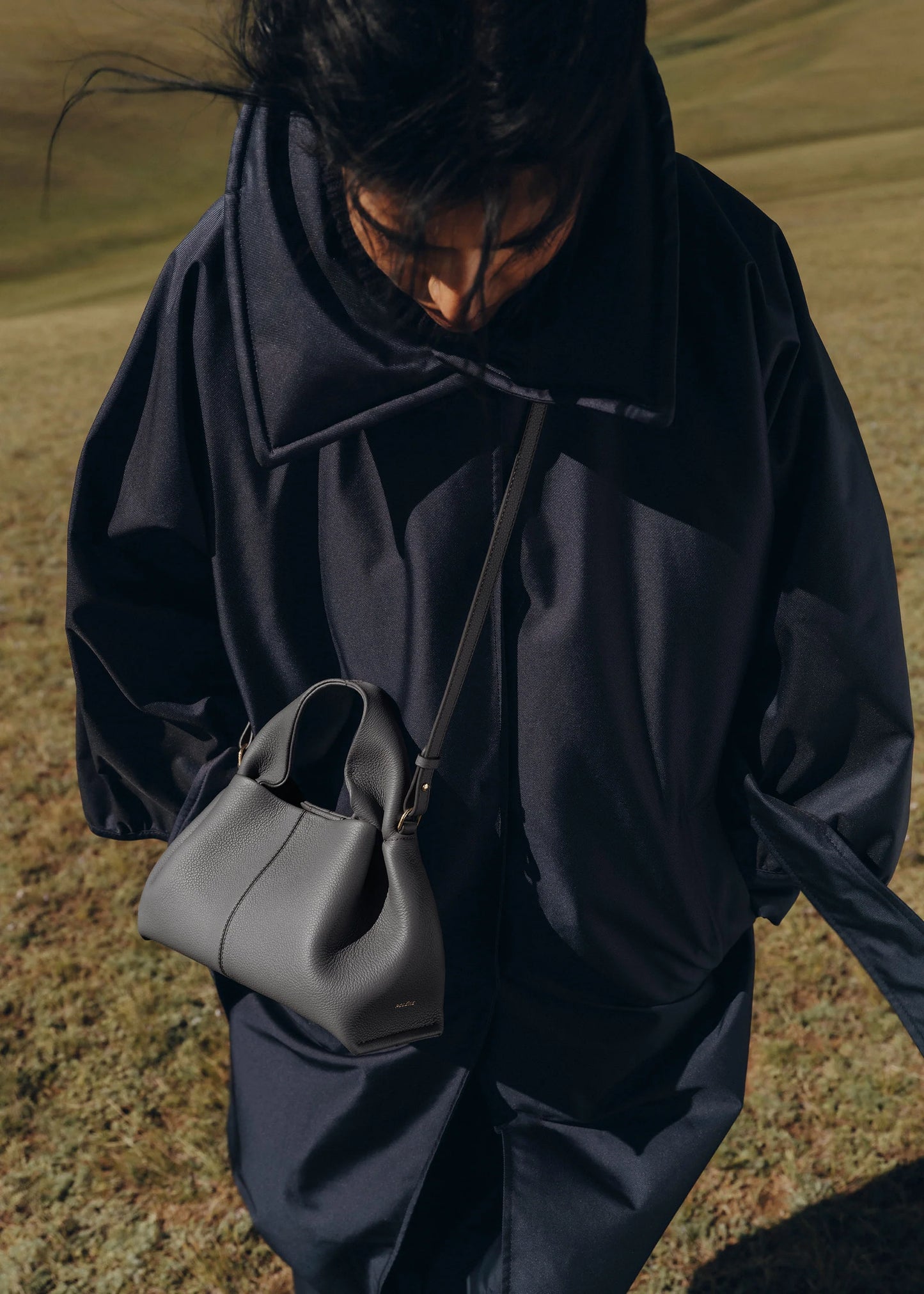 Elegant Minimalist Slate Grey Pebbled Leather Top Handle Handbag with Soft Sculptural Silhouette and Gold Hardware – Modern Quiet Luxury Designer Accessory Product Shot