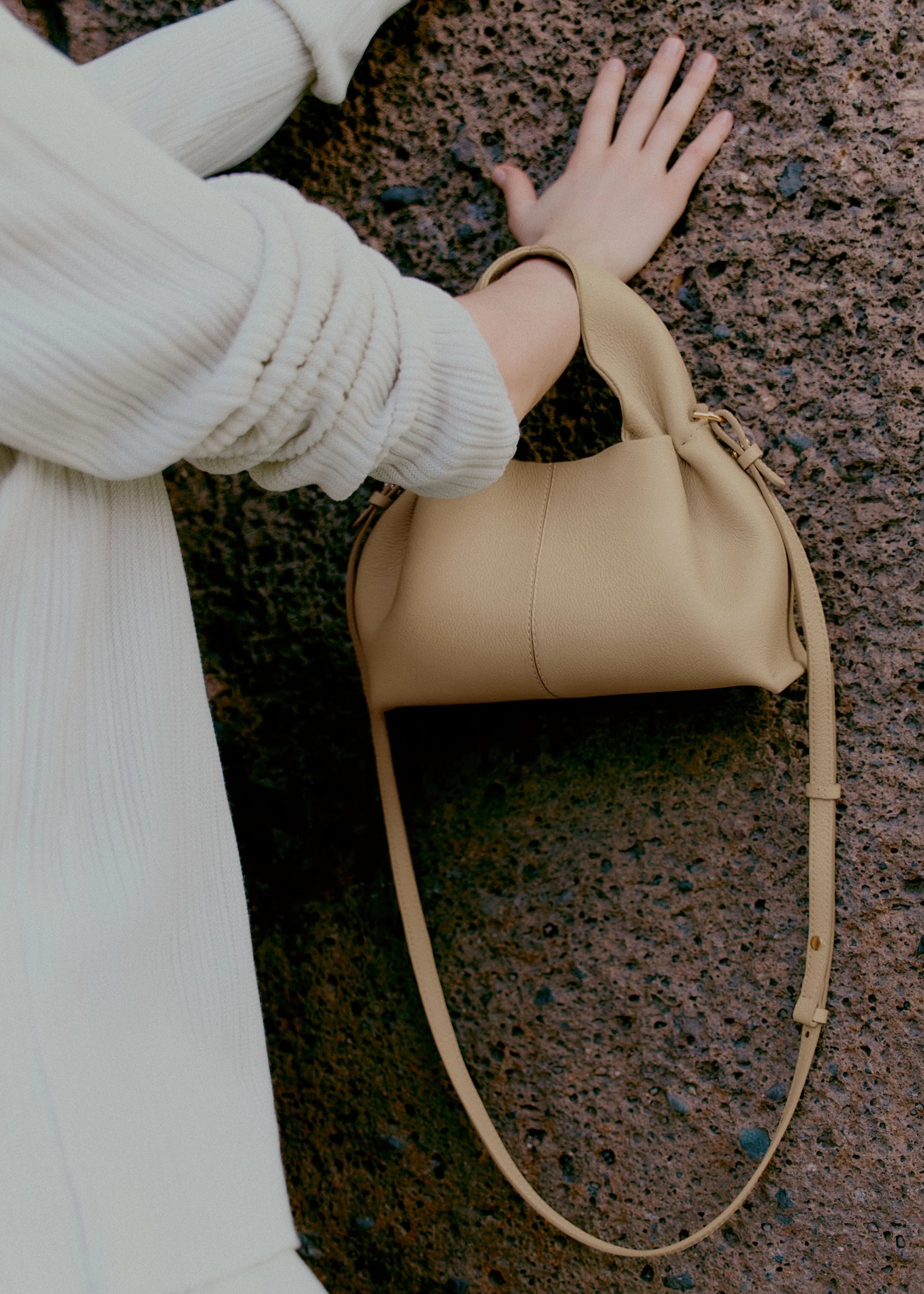 Relaxed Minimalist Coastal Look Featuring Ribbed Oatmeal Knit Cardigan and Soft Neutral Wide-Leg Trousers with Structured Sand Beige Leather Crossbody Handbag – Effortless Quiet Luxury Womenswear Editorial Style