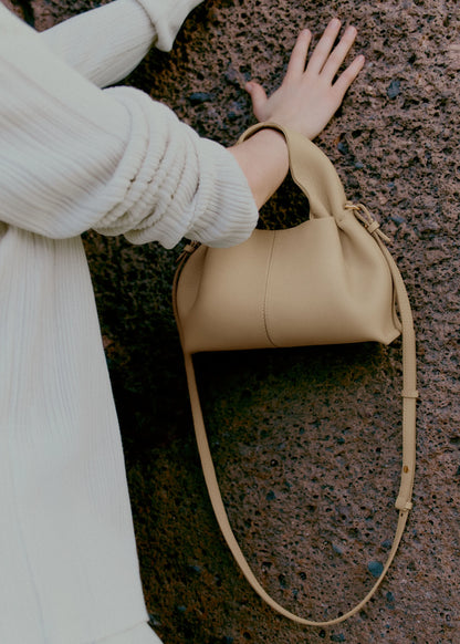Relaxed Minimalist Coastal Look Featuring Ribbed Oatmeal Knit Cardigan and Soft Neutral Wide-Leg Trousers with Structured Sand Beige Leather Crossbody Handbag – Effortless Quiet Luxury Womenswear Editorial Style