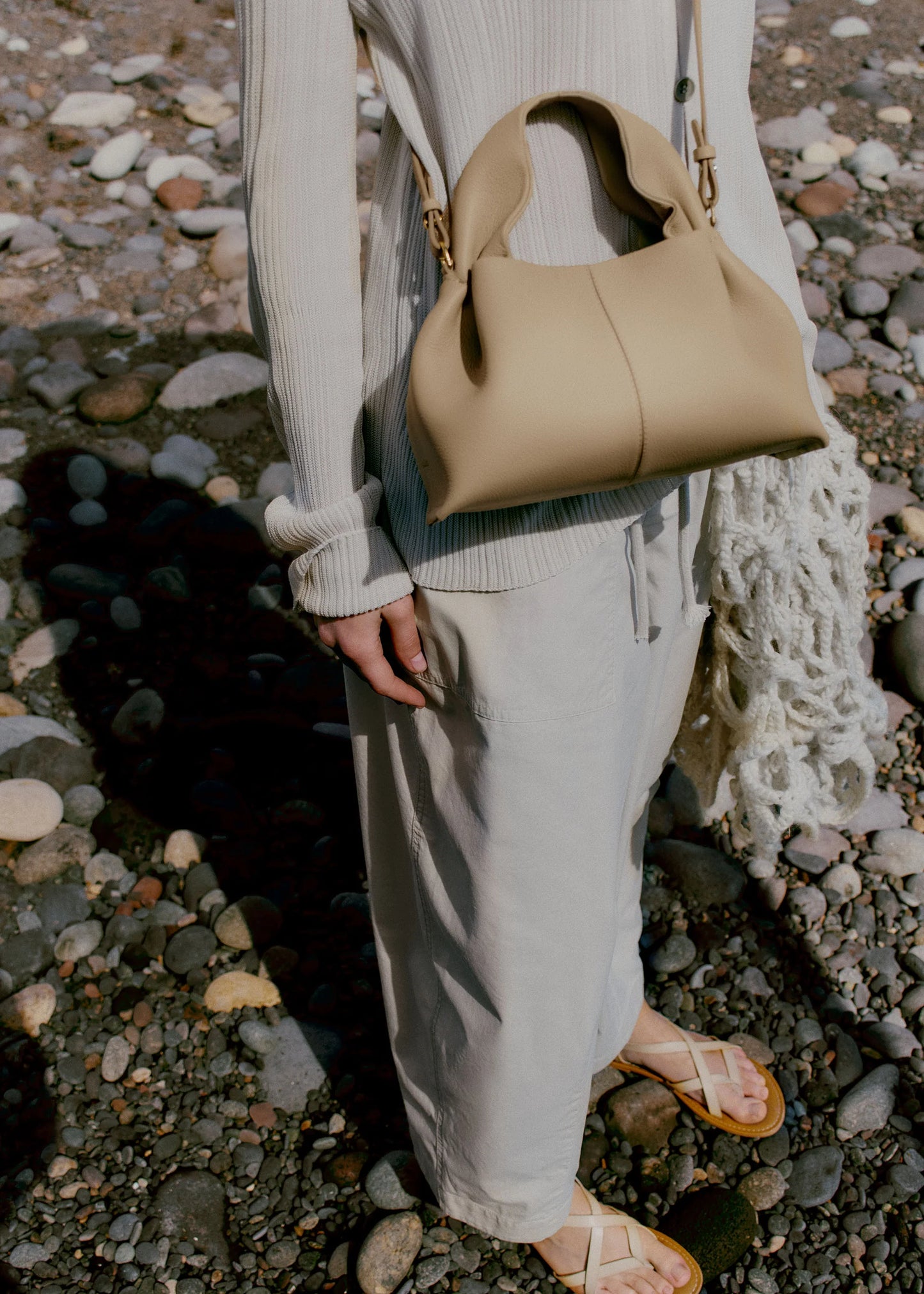 Relaxed Minimalist Coastal Look Featuring Ribbed Oatmeal Knit Cardigan and Soft Neutral Wide-Leg Trousers with Structured Sand Beige Leather Crossbody Handbag – Effortless Quiet Luxury Womenswear Editorial Style