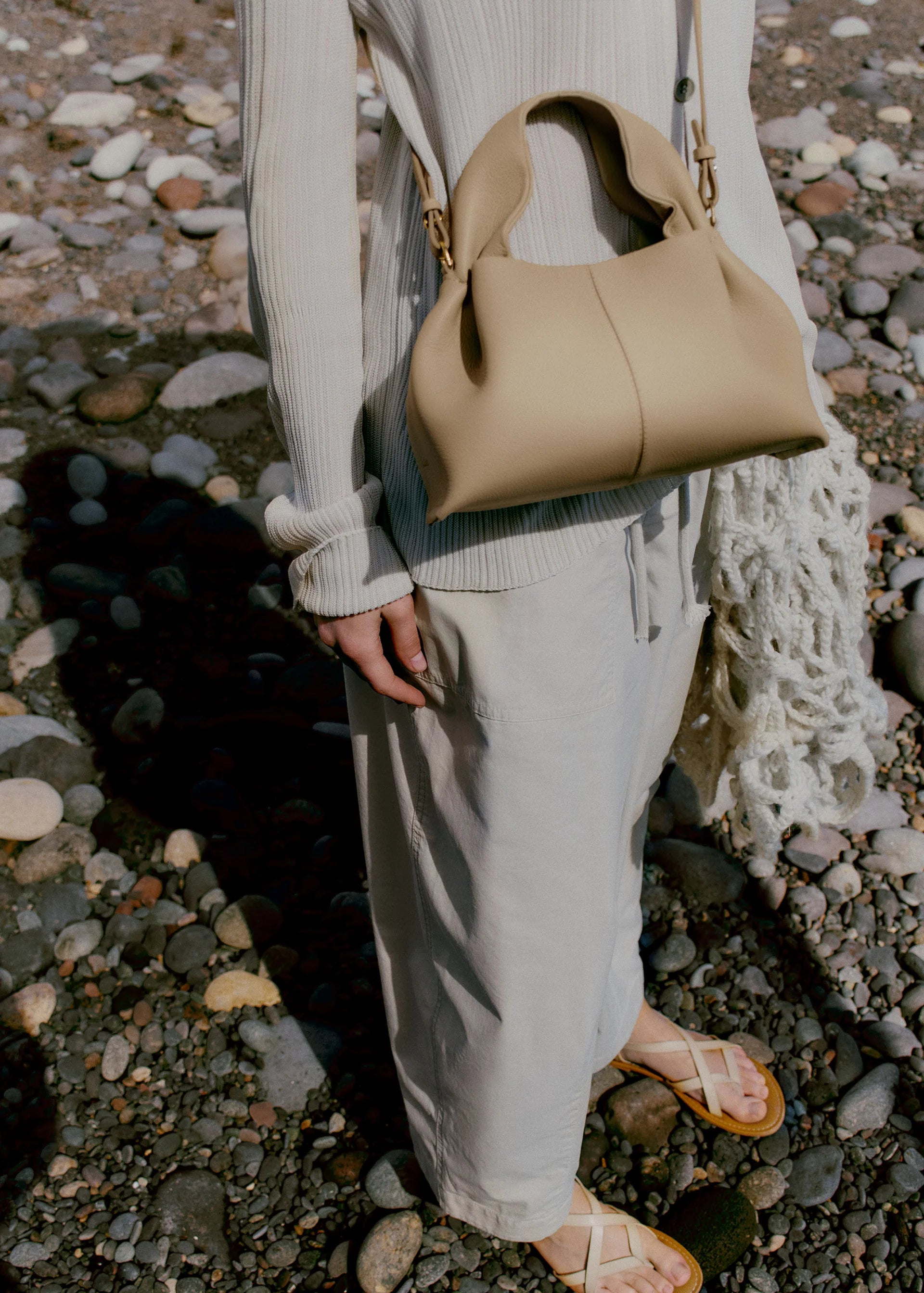 Relaxed Minimalist Coastal Look Featuring Ribbed Oatmeal Knit Cardigan and Soft Neutral Wide-Leg Trousers with Structured Sand Beige Leather Crossbody Handbag – Effortless Quiet Luxury Womenswear Editorial Style