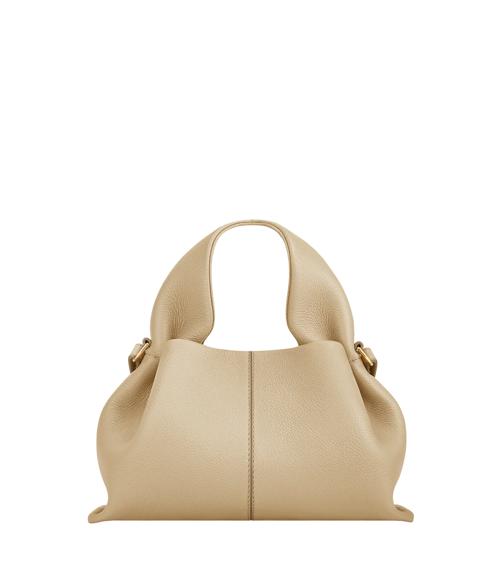 Relaxed Minimalist Coastal Look Featuring Ribbed Oatmeal Knit Cardigan and Soft Neutral Wide-Leg Trousers with Structured Sand Beige Leather Crossbody Handbag – Effortless Quiet Luxury Womenswear Editorial Style