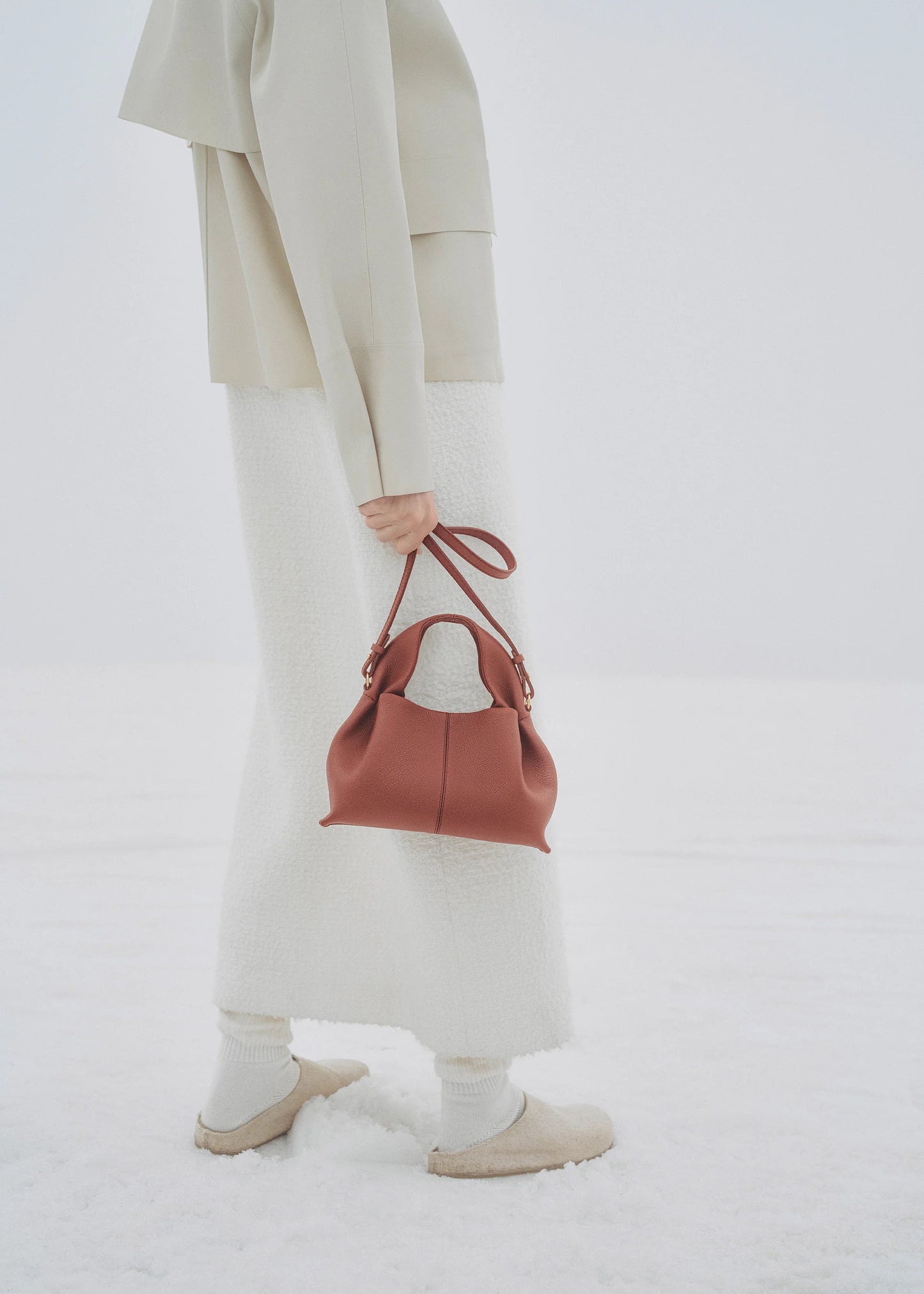 Elegant Minimalist Winter Look Featuring Soft Ivory Textured Coat with Structured Deep Burgundy Leather Crossbody Top Handle Handbag – Timeless Quiet Luxury Womenswear Editorial Style