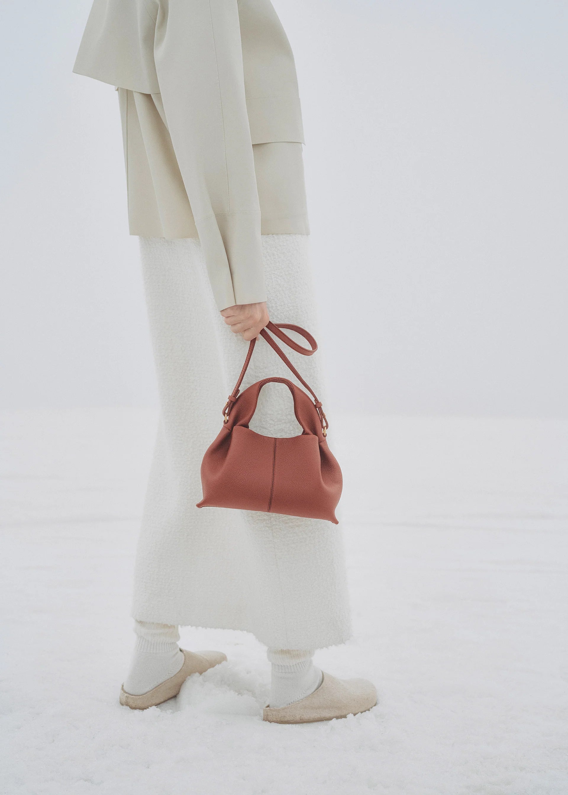 Elegant Minimalist Winter Look Featuring Soft Ivory Textured Coat with Structured Deep Burgundy Leather Crossbody Top Handle Handbag – Timeless Quiet Luxury Womenswear Editorial Style