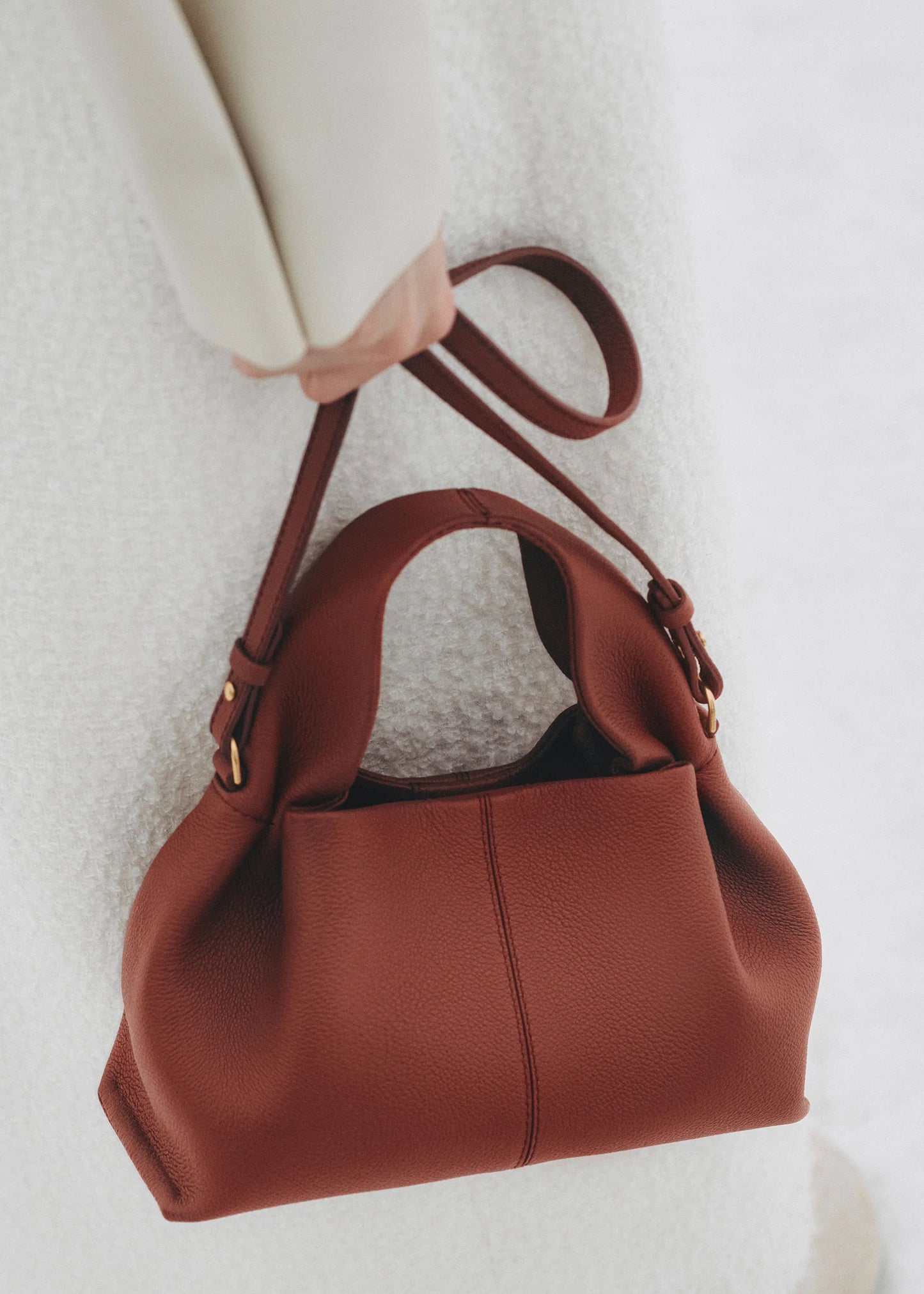 Elegant Minimalist Winter Look Featuring Soft Ivory Textured Coat with Structured Deep Burgundy Leather Crossbody Top Handle Handbag – Timeless Quiet Luxury Womenswear Editorial Style