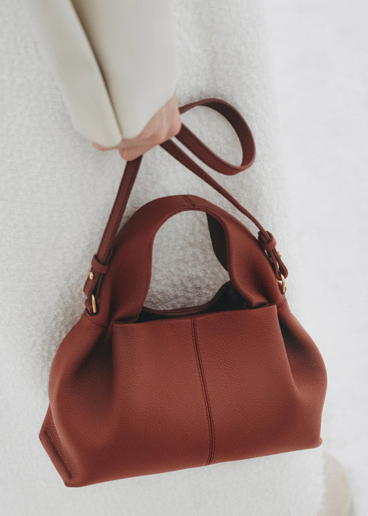 Elegant Minimalist Winter Look Featuring Soft Ivory Textured Coat with Structured Deep Burgundy Leather Crossbody Top Handle Handbag – Timeless Quiet Luxury Womenswear Editorial Style