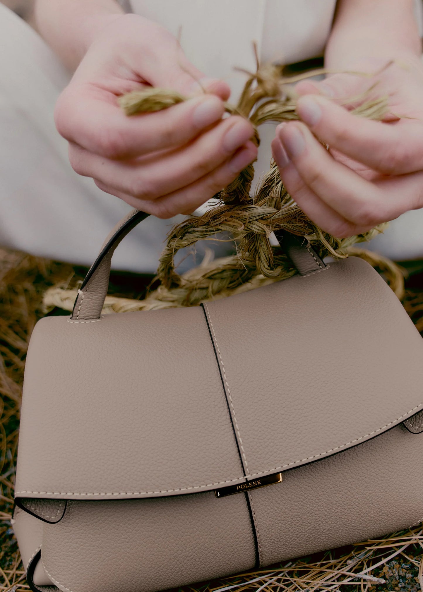 Taupe Leather Top-Handle Shoulder Bag Styled on Model in Neutral Sleeveless Dress