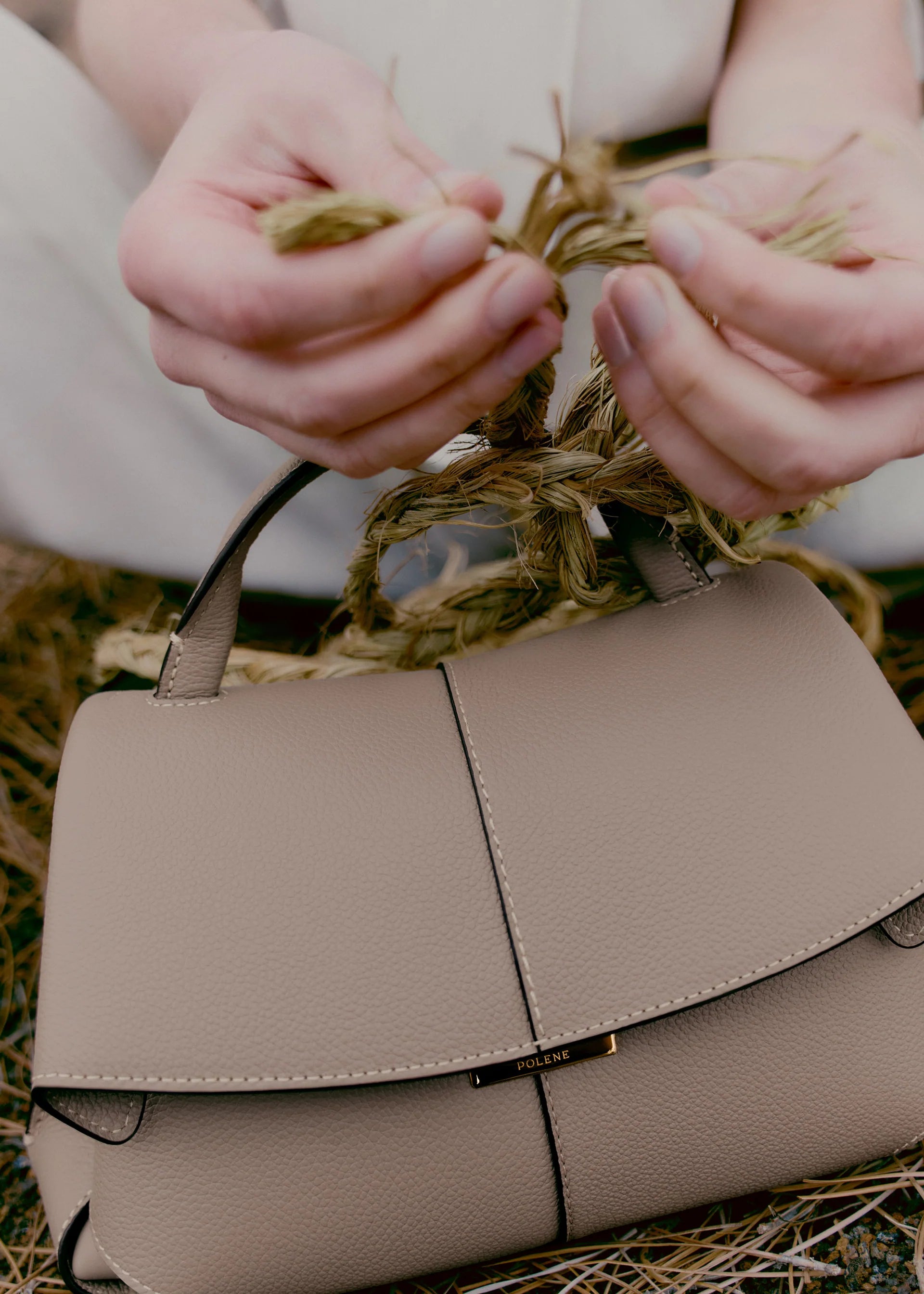Taupe Leather Top-Handle Shoulder Bag Styled on Model in Neutral Sleeveless Dress