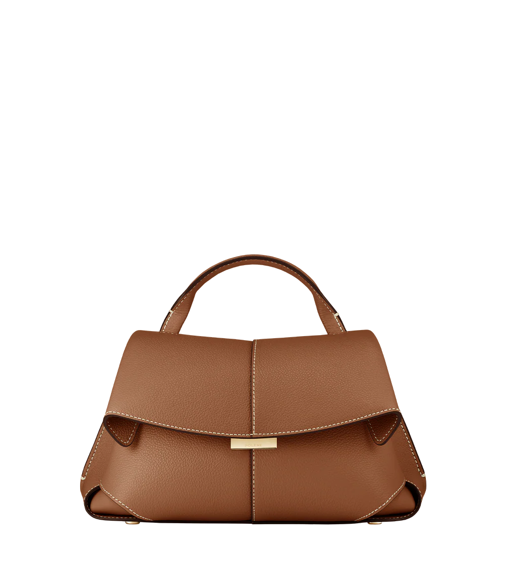 Elegant Tan Pebbled Leather Top-Handle Mini Handbag with Fold-Over Flap and Gold-Tone Hardware Styled with Neutral Knit Ensemble