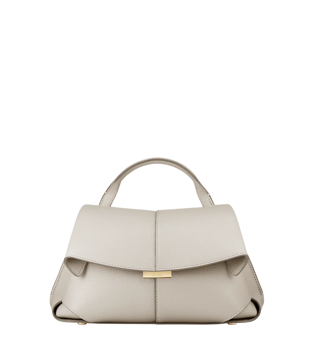Elegant Ivory Pebbled Leather Top-Handle Shoulder Bag with Fold-Over Flap and Adjustable Strap Styled in Cozy Knitwear Portrait