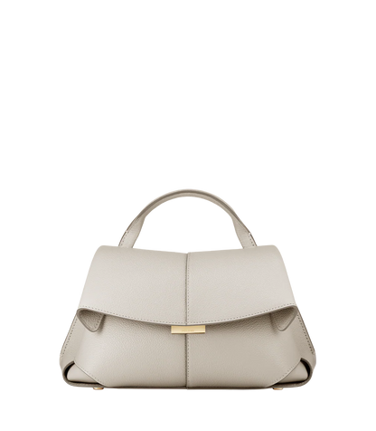 Elegant Ivory Pebbled Leather Top-Handle Shoulder Bag with Fold-Over Flap and Adjustable Strap Styled in Cozy Knitwear Portrait