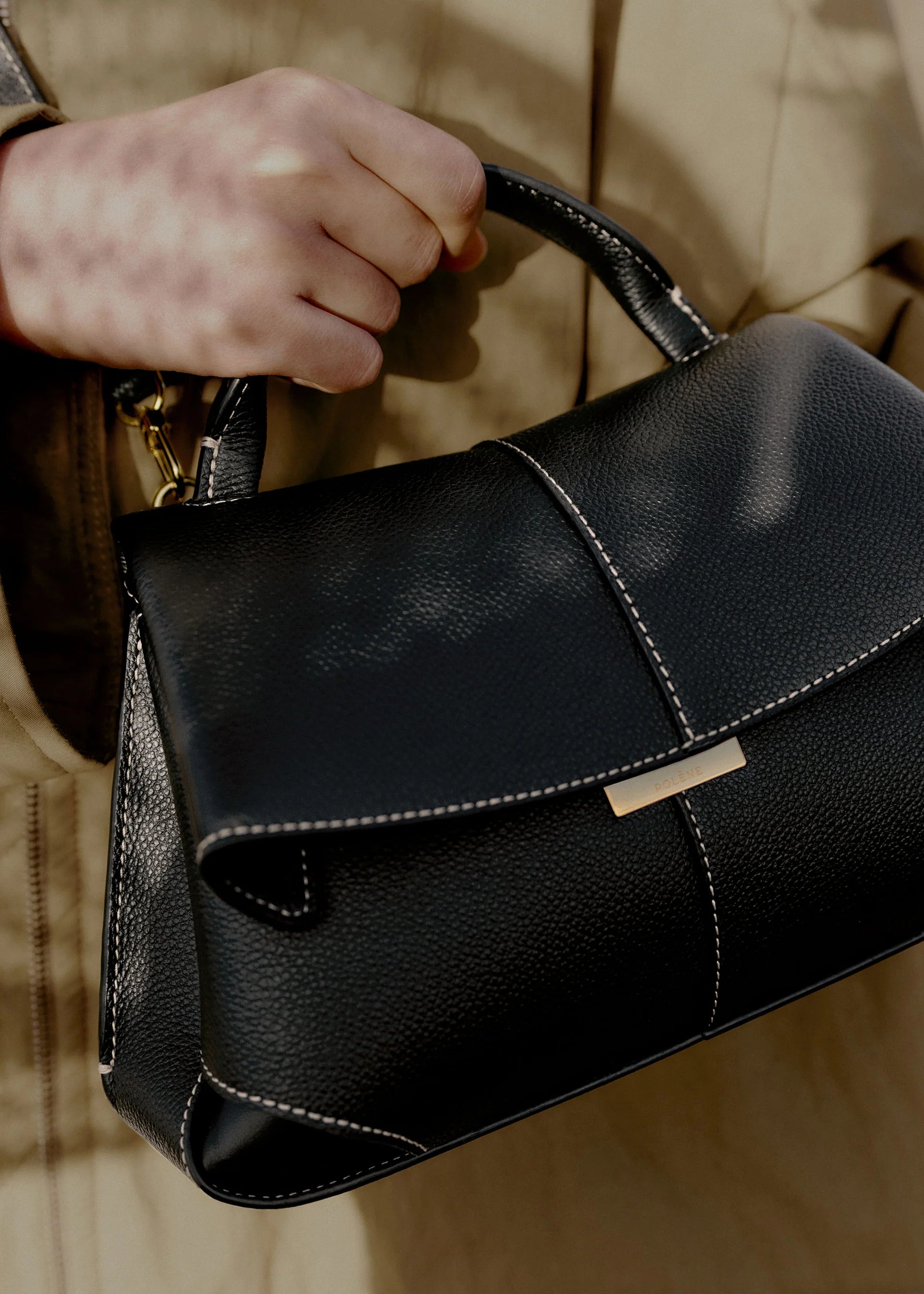 Elegant Black Pebbled Leather Top-Handle Handbag with Fold-Over Flap, Contrast Stitching, and Gold-Tone Hardware