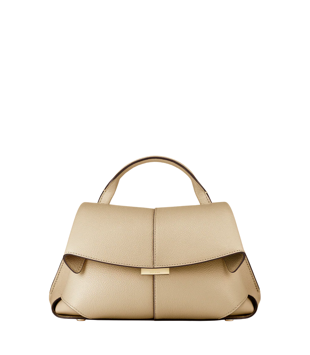 Elegant Beige Pebbled Leather Top-Handle Handbag with Fold-Over Flap and Minimalist Structured Silhouette Styled in Soft Neutral Look