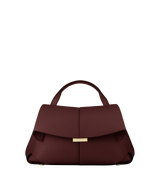 Elegant Burgundy Pebbled Leather Top-Handle Shoulder Bag with Fold-Over Flap and Gold-Tone Hardware Styled with Cozy Grey Outerwear