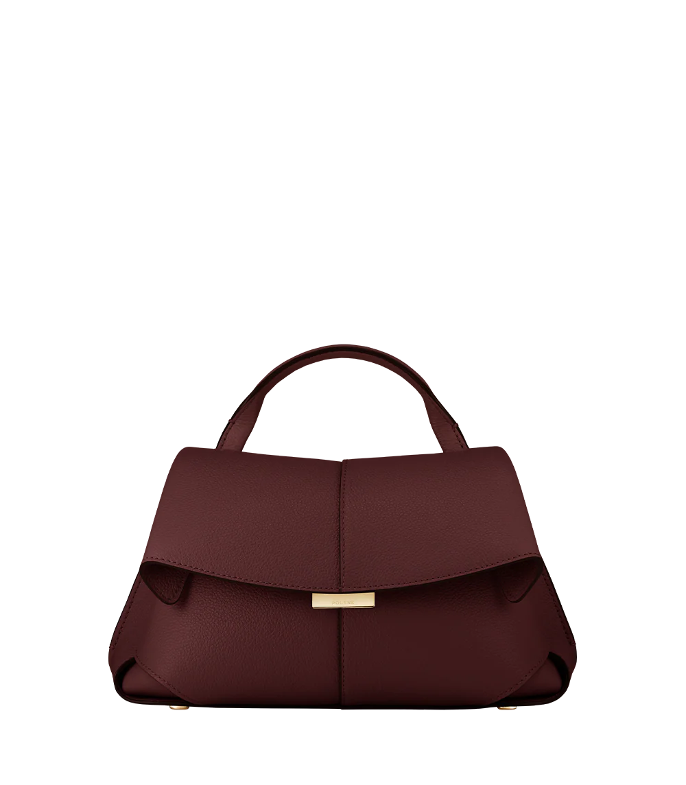 Elegant Burgundy Pebbled Leather Top-Handle Shoulder Bag with Fold-Over Flap and Gold-Tone Hardware Styled with Cozy Grey Outerwear