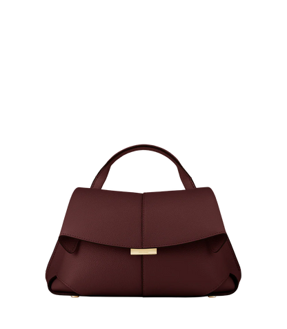 Elegant Burgundy Pebbled Leather Top-Handle Shoulder Bag with Fold-Over Flap and Gold-Tone Hardware Styled with Cozy Grey Outerwear
